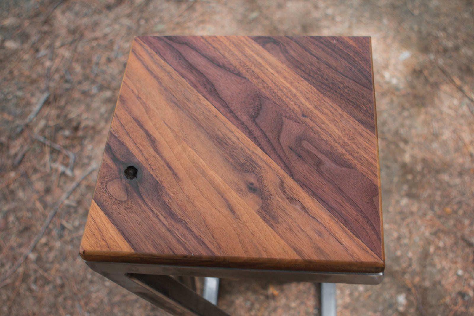 Wooden stool with a brown grain pattern on a blurred background