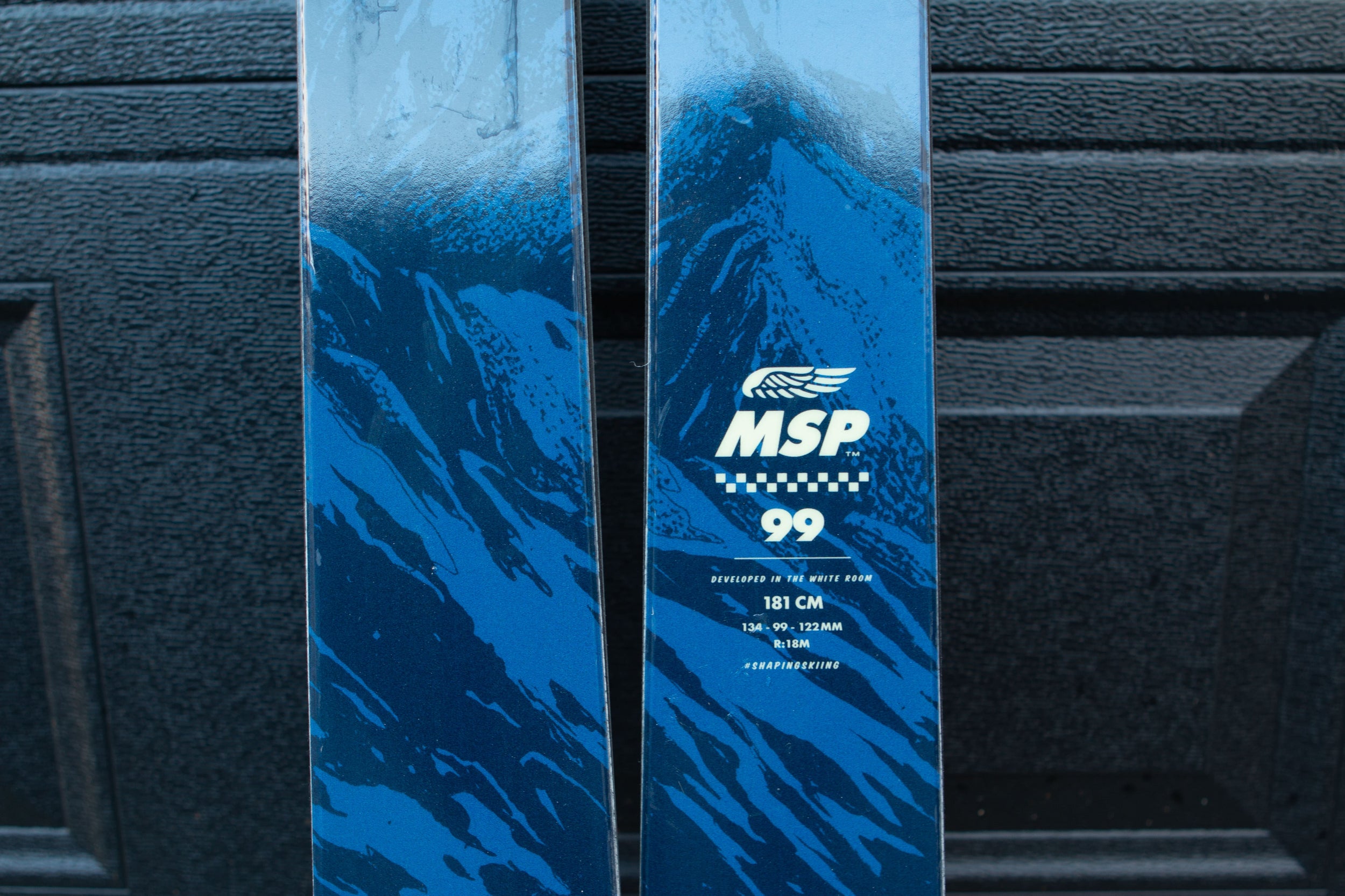 Blue ski with MSP branding on a black background