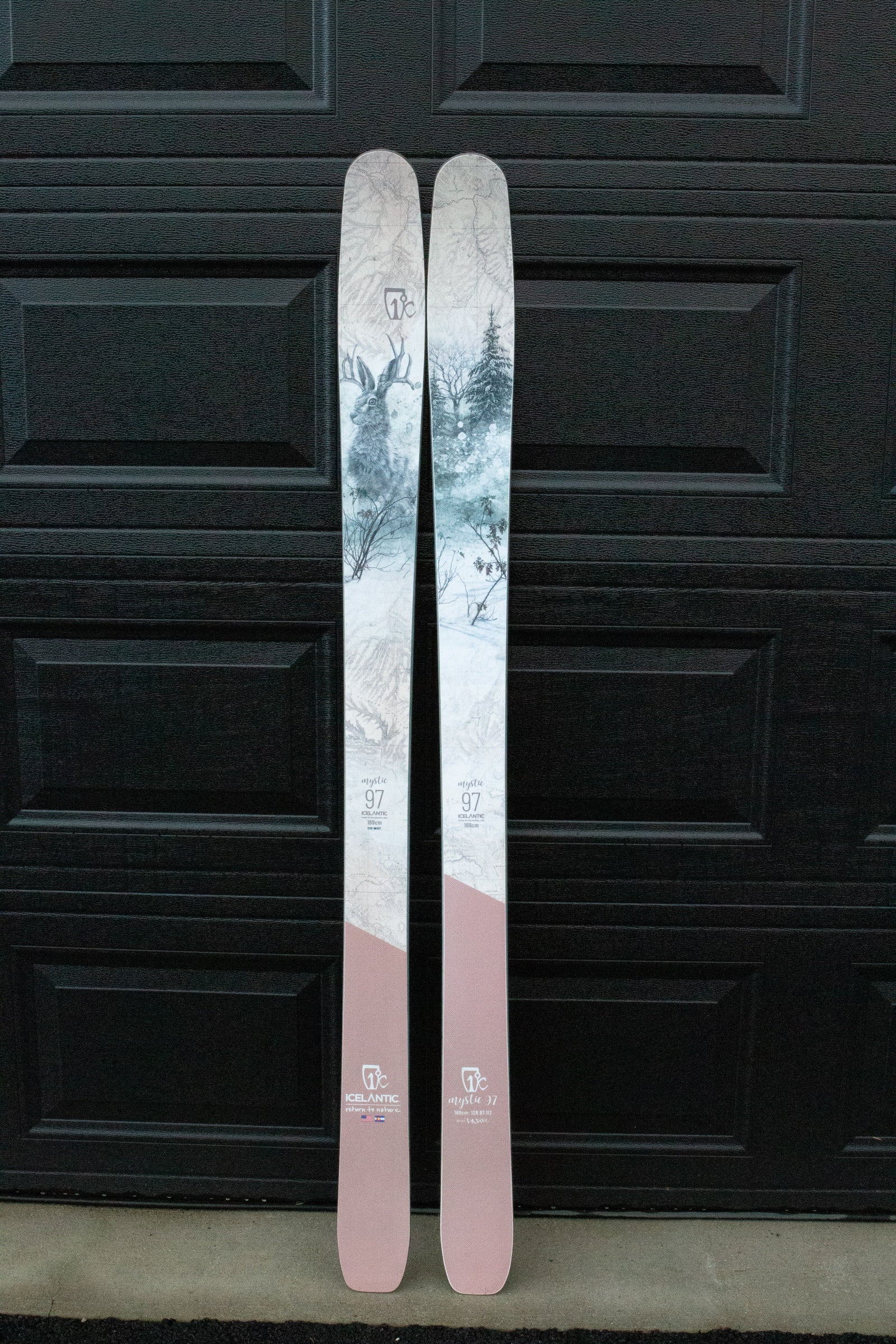 Two skis with a scenic design on a black background