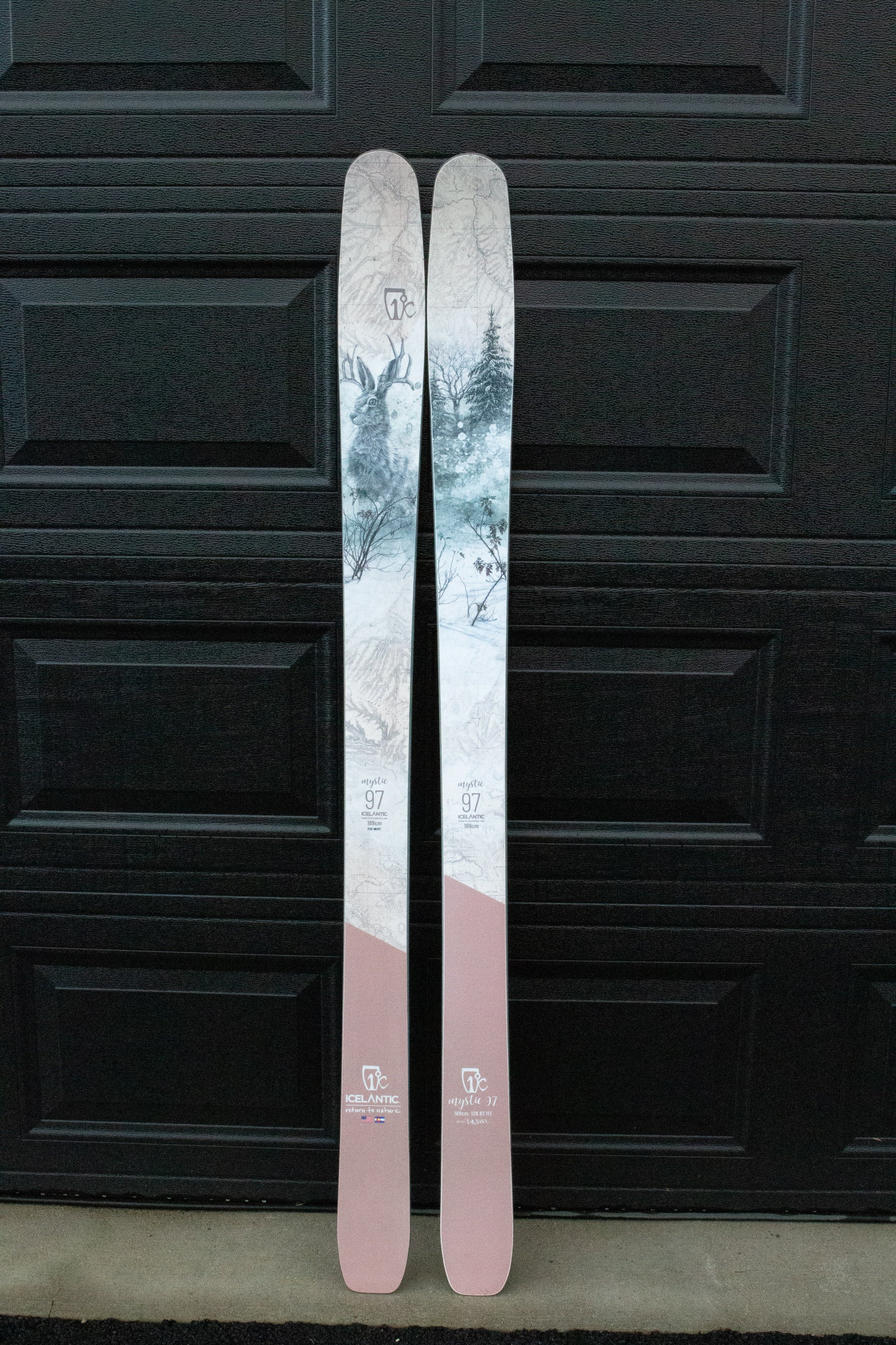 Two skis with a scenic design on a black background