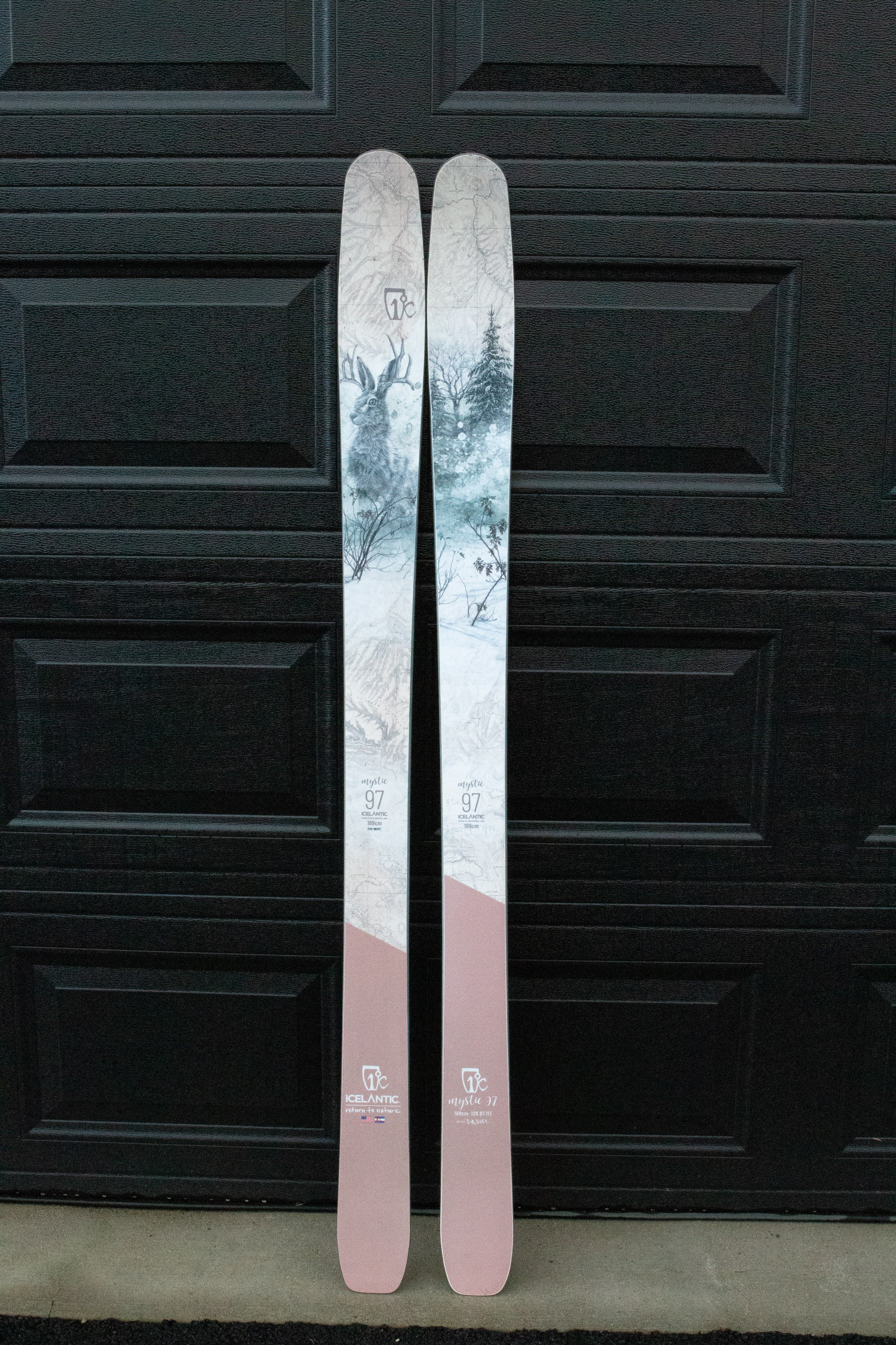 Two skis with a scenic design on a black background