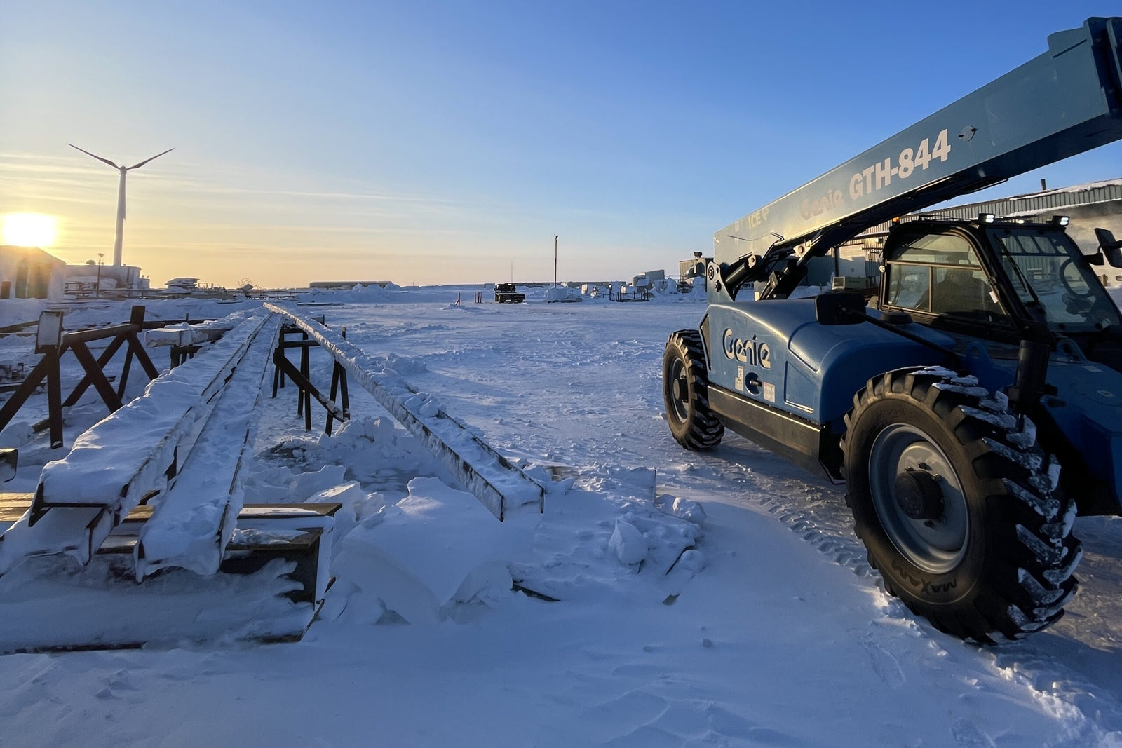 Heavy-duty vehicle on a snowy landscape with a clear sky
