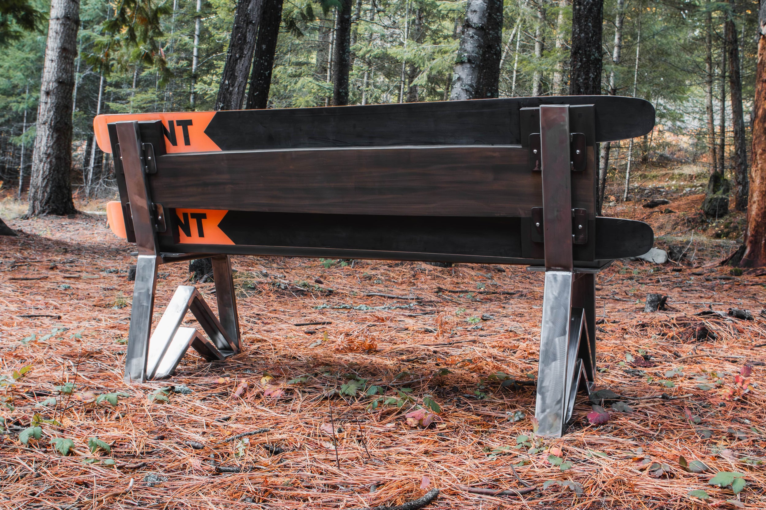 Wooden bench with 'Went' branding in a forest setting